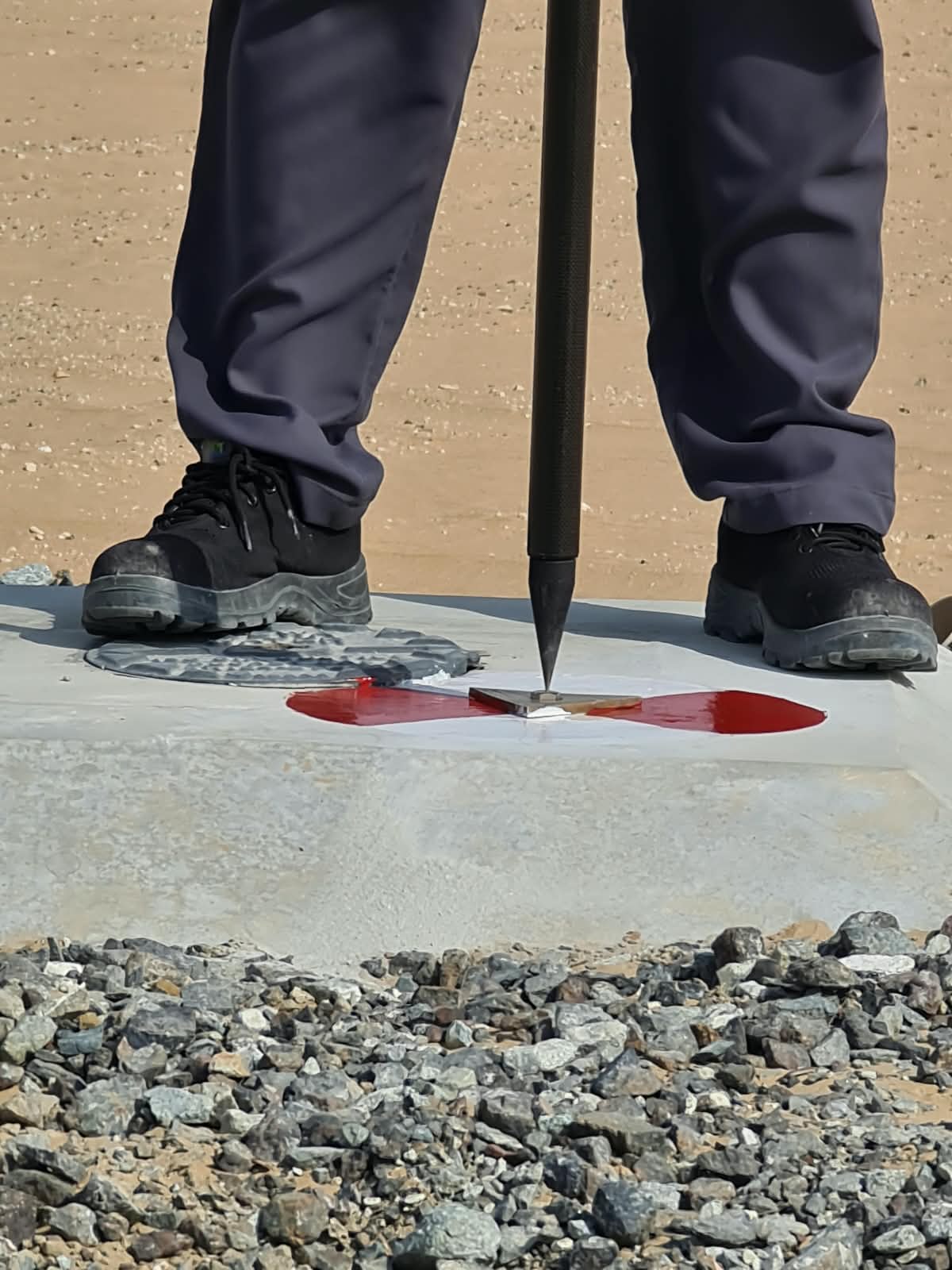 Surveyor's boot beside a marked control point