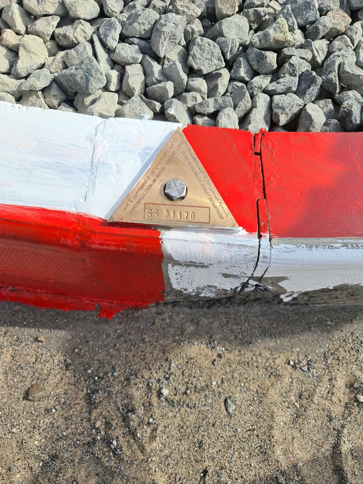 Dubai Municipality Survey Department official benchmark plate on a Fortress Surveying control point