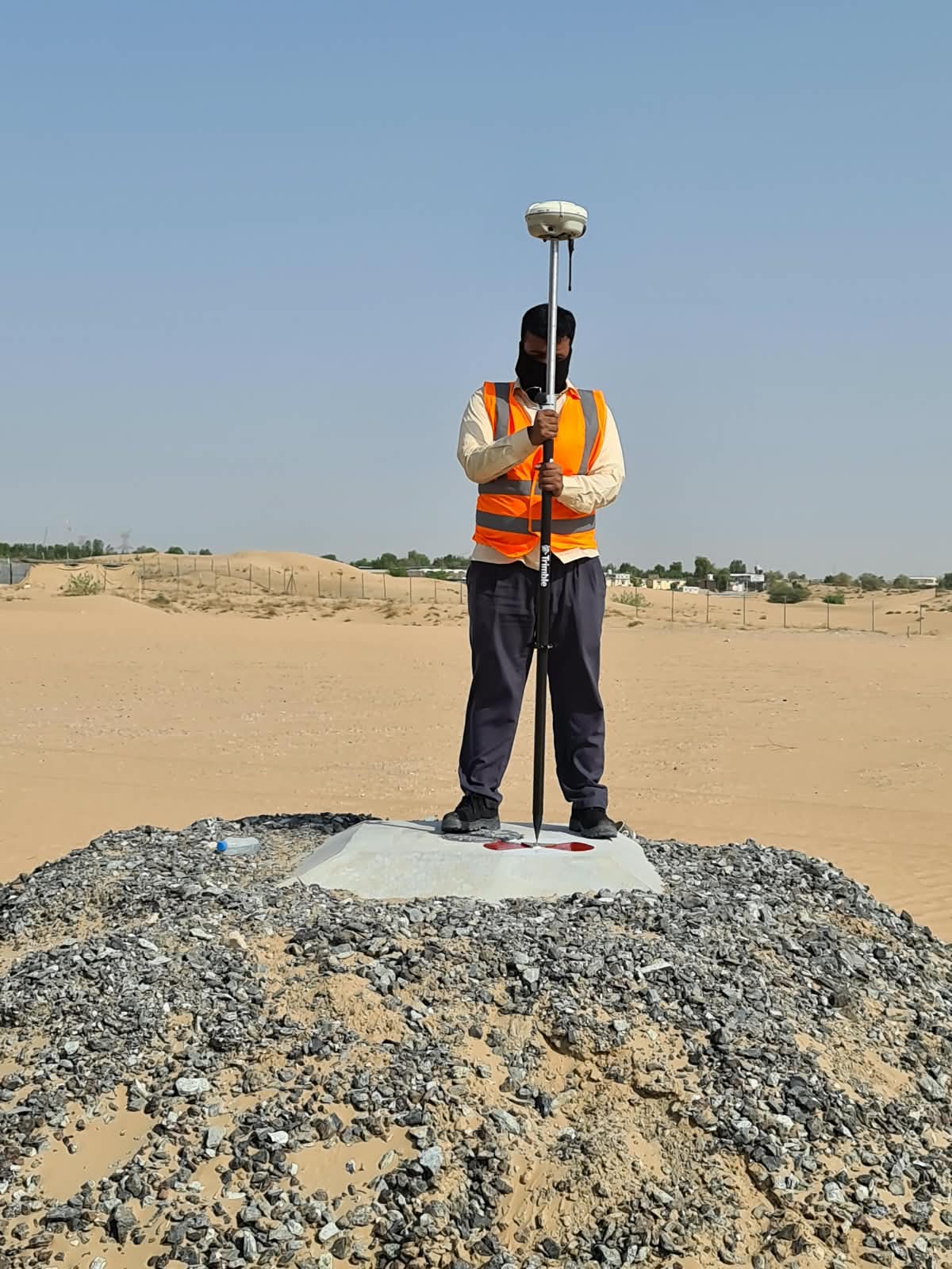 GNSS rover on a desert control point in Dubai